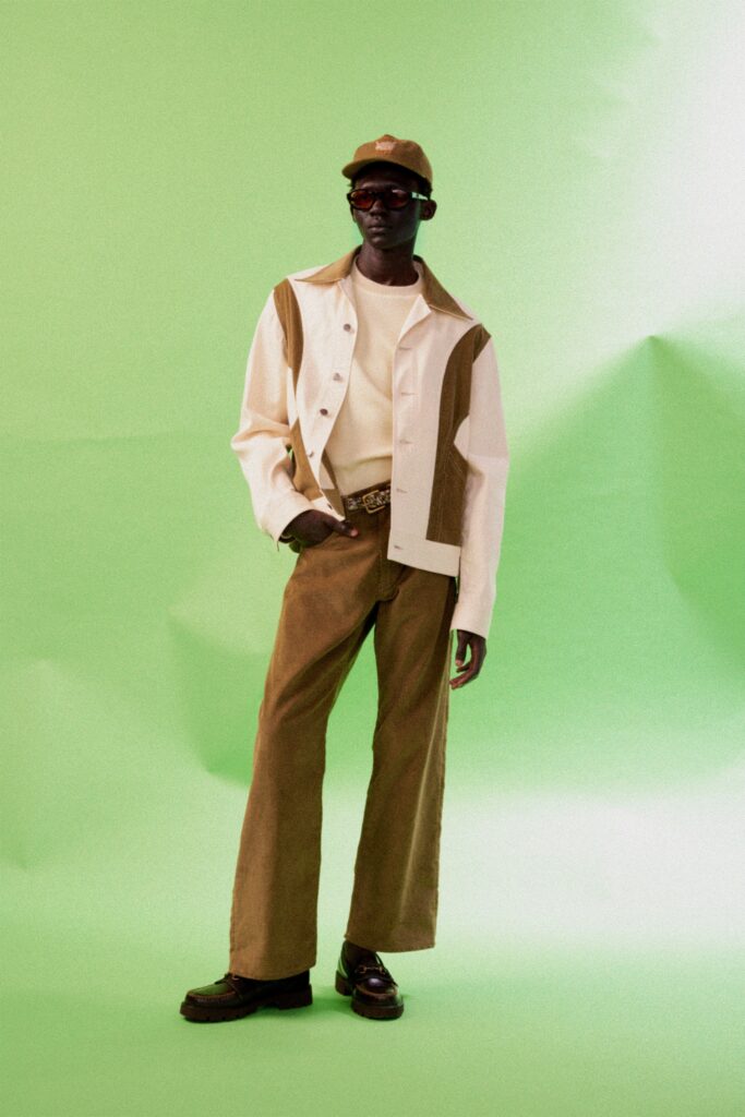 A relaxed fit white long-sleeve jacket with brown wide-leg pants.