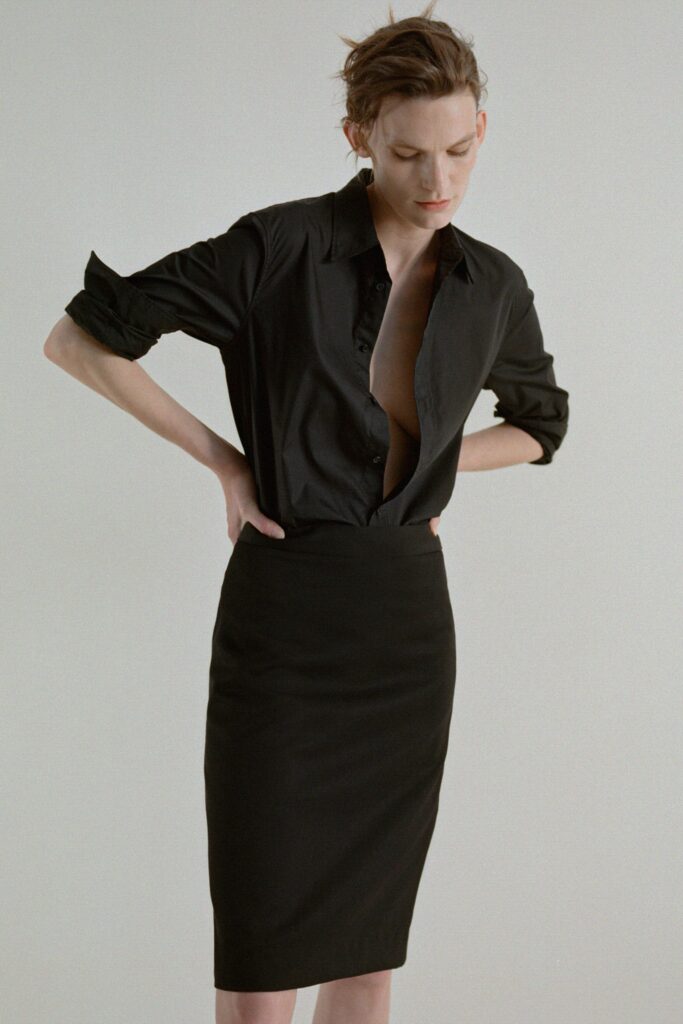 A fitted black shirt with a collar paired with a black pencil skirt.