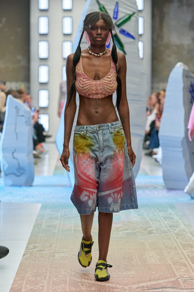 A relaxed fit multicolor sleeveless top paired with printed denim shorts.