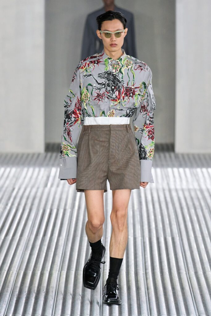 A relaxed gray printed long-sleeve shirt paired with stylish shorts.