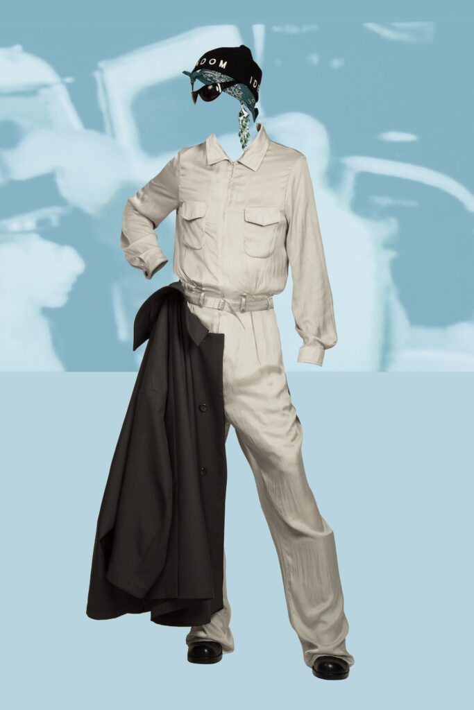 A relaxed black jacket paired with beige pants, featuring a collared design and buttoned details.