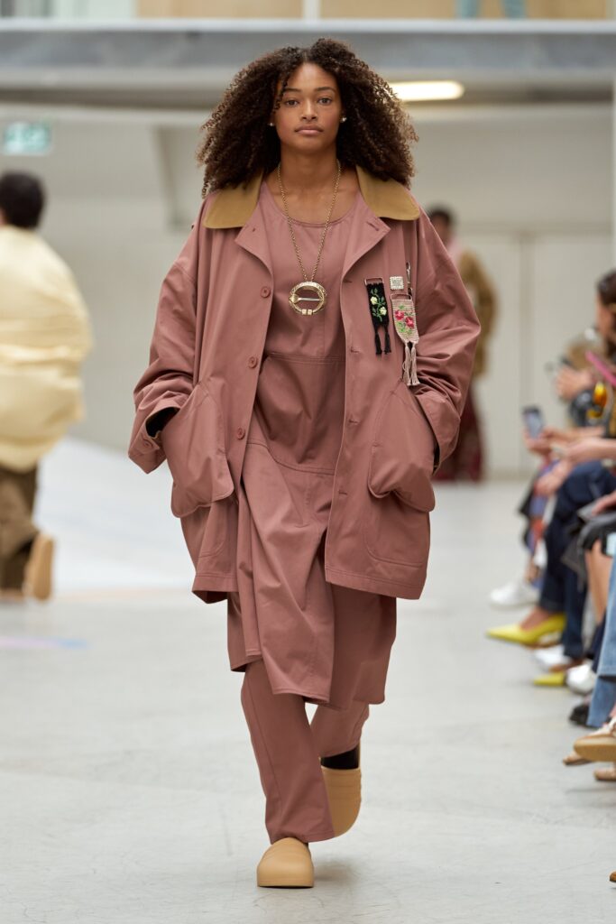 A relaxed brown cotton coat with long sleeves and a collared design, paired with matching pants.