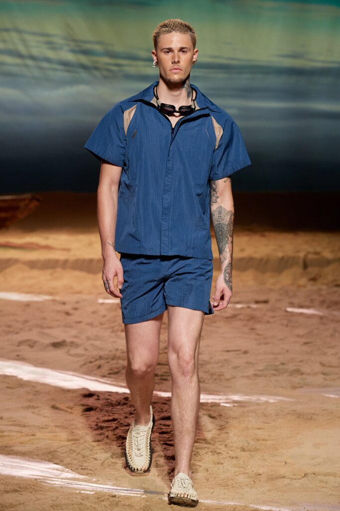 A relaxed blue striped shirt with a collared neckline paired with matching shorts.