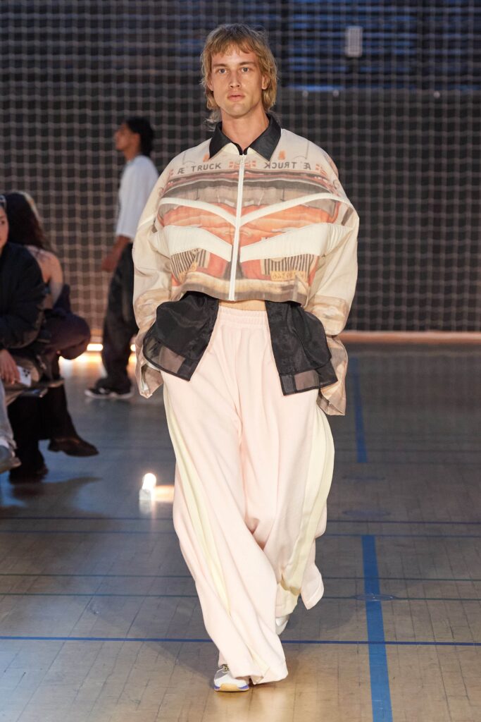 A relaxed white cotton jacket with long sleeves and a collared design paired with matching pants.
