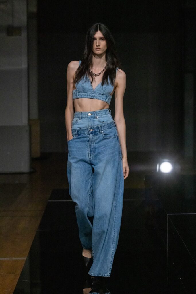 A relaxed blue denim sleeveless top paired with high-waisted wide-leg pants.