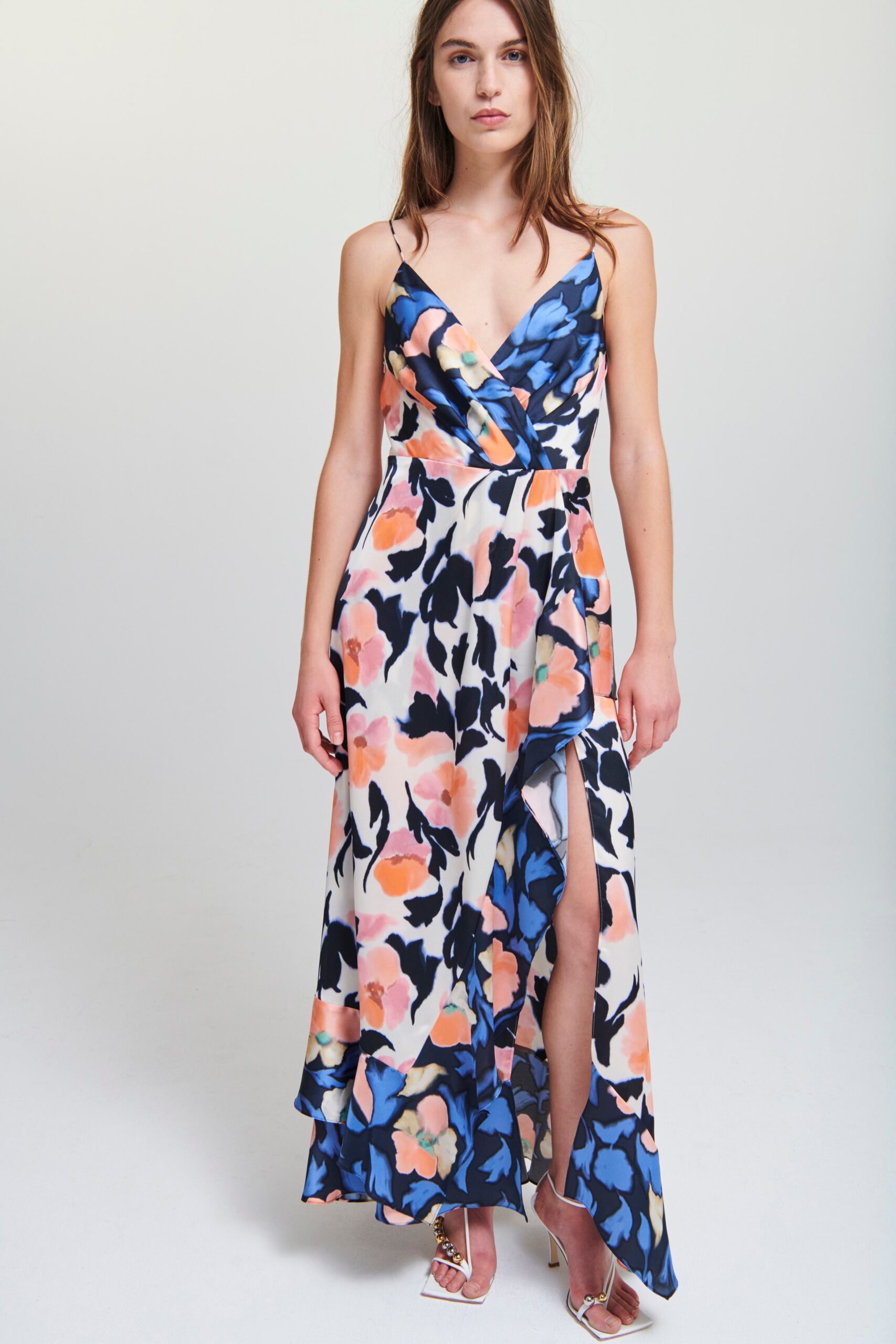 A fitted floral printed sleeveless dress with a V-neckline and flared silhouette.