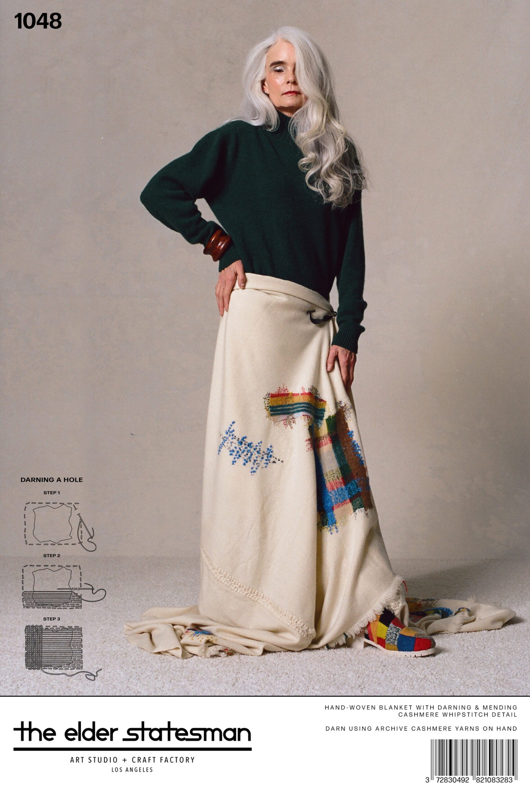 A relaxed green cashmere sweater dress with long sleeves and a layered design.