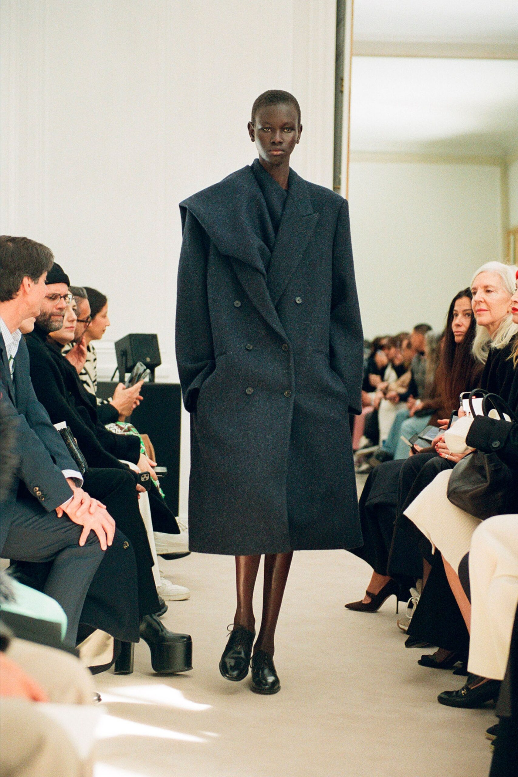 An oversized blue wool coat with long sleeves and a double-breasted design.