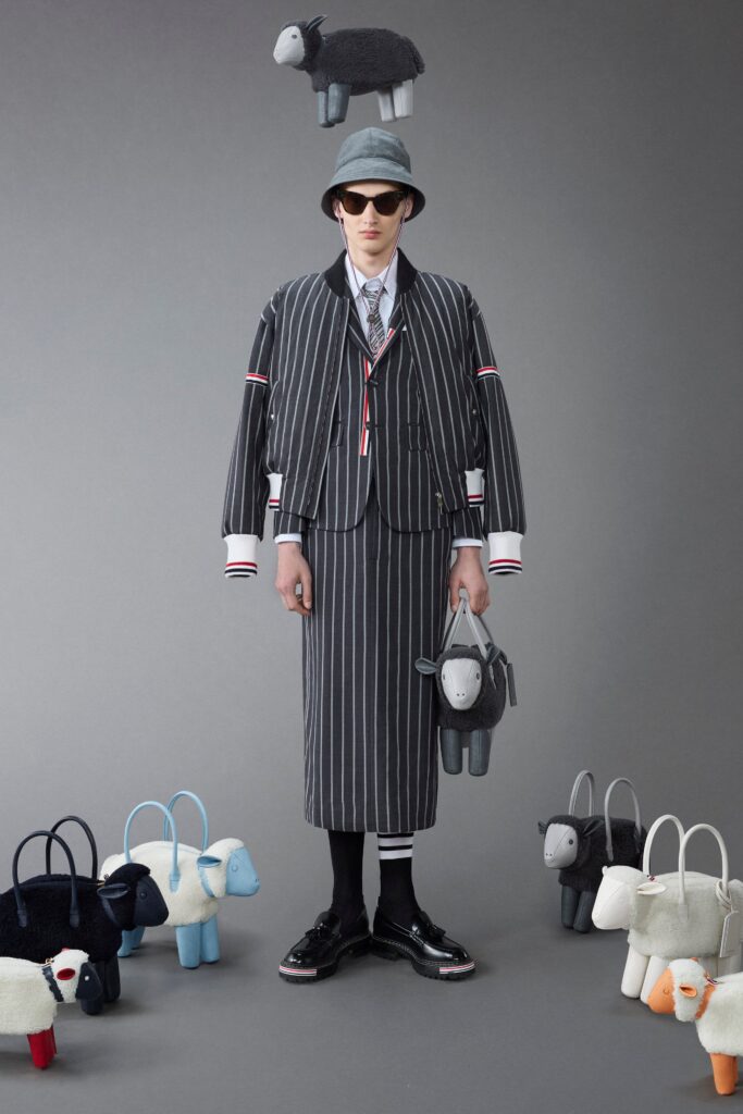 A relaxed black and white striped suit with a collared shirt and high-waisted skirt.