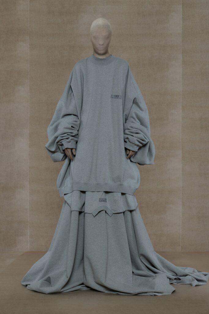 An oversized gray cotton dress with long sleeves and a layered design.