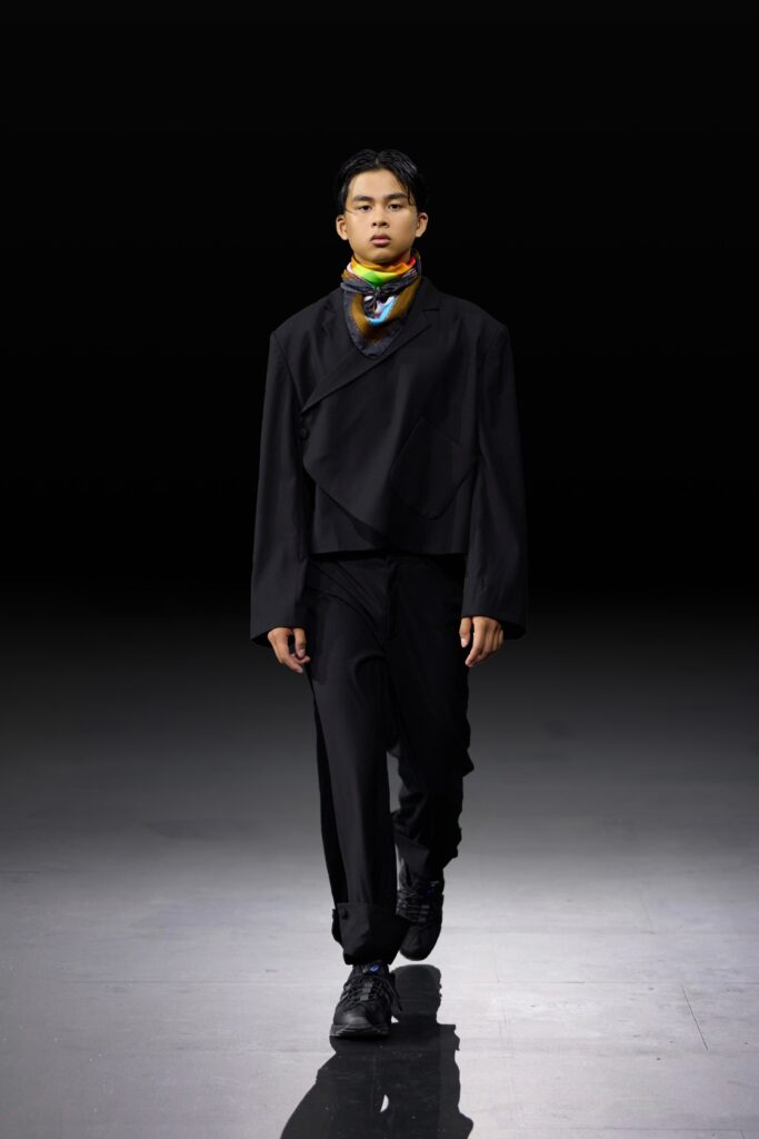 An oversized black jacket paired with black pants, creating a sleek and modern silhouette.