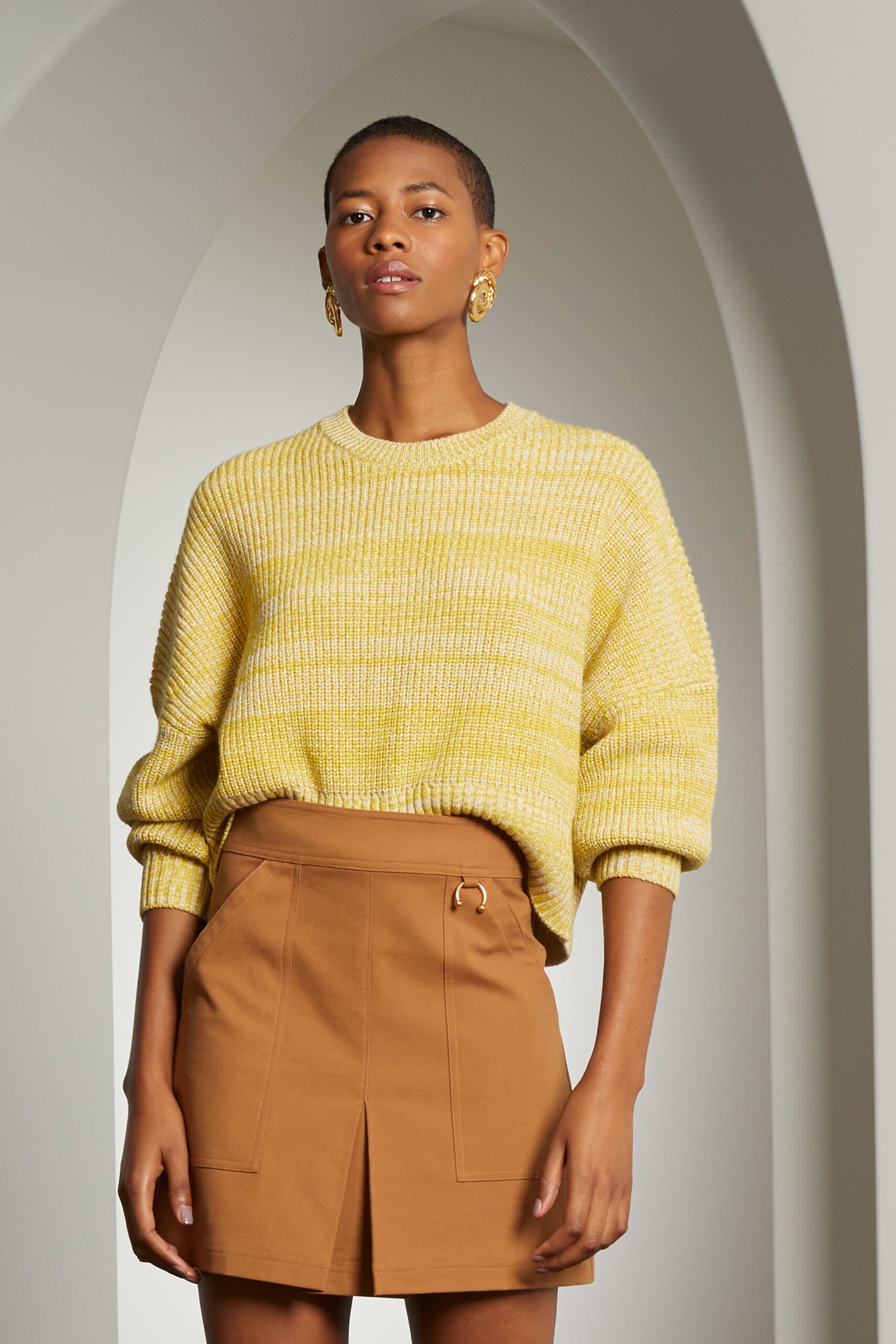 yellow oversized sweater and brown skirt