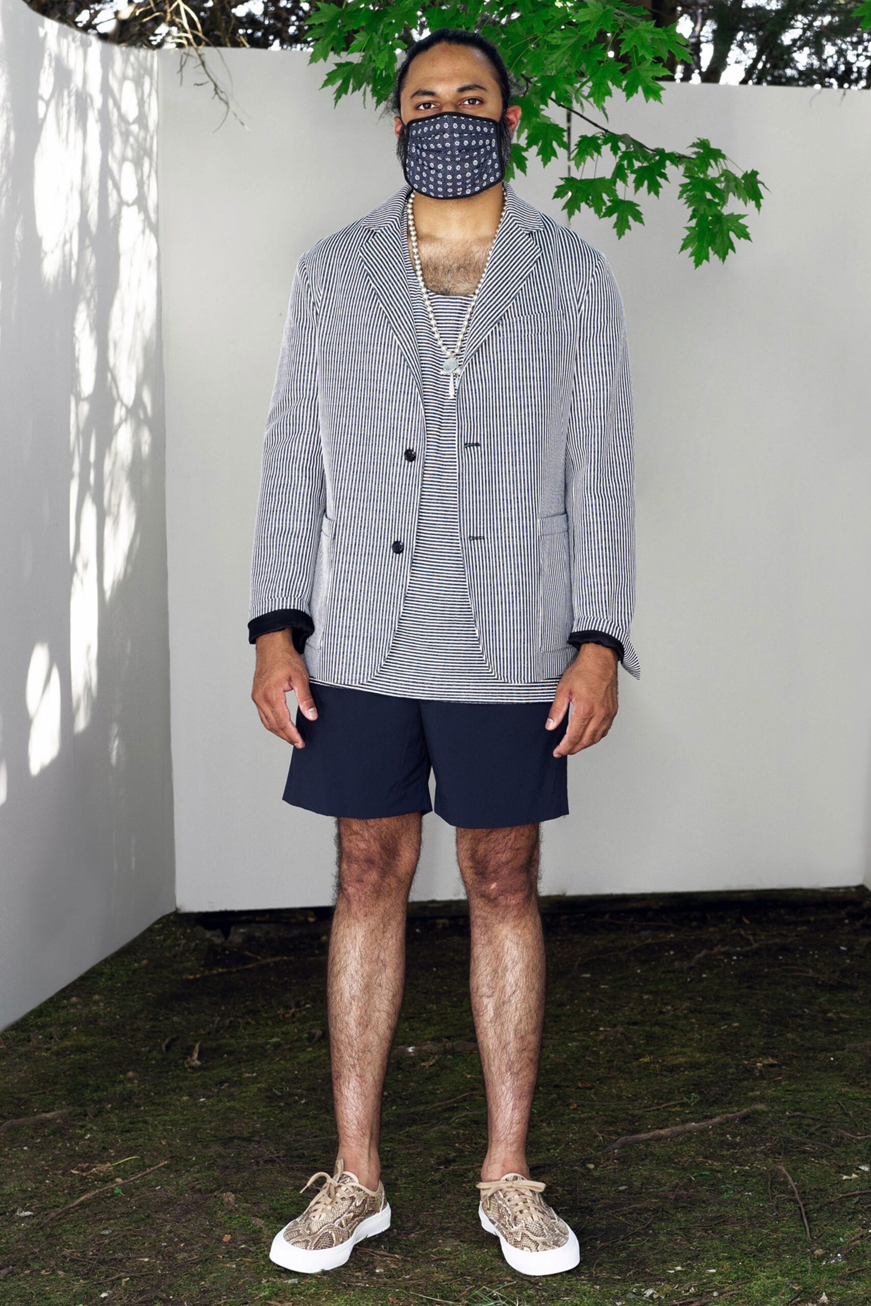 A relaxed black and white striped blazer paired with matching shorts for a casual look.