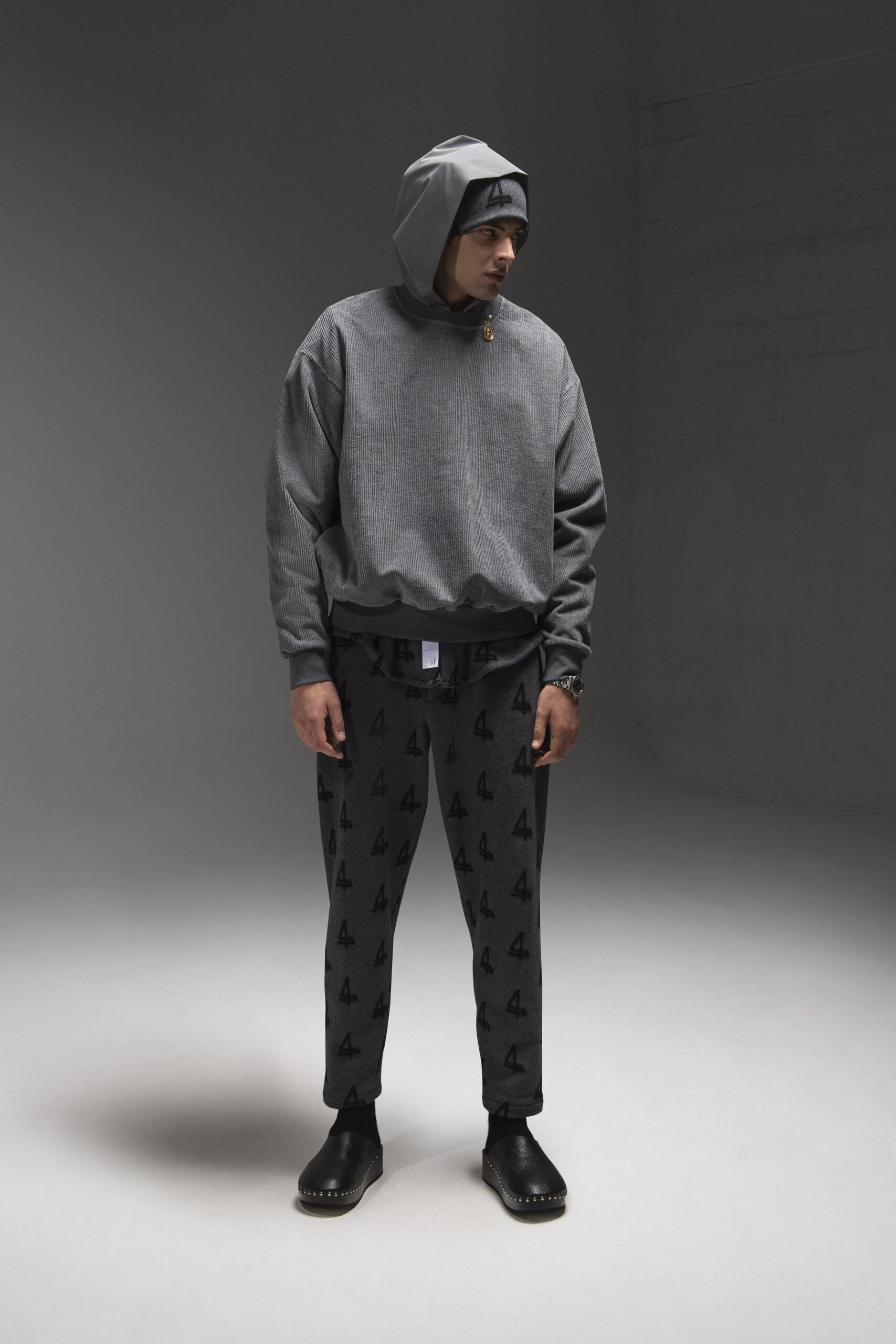 A relaxed gray hoodie with a hood and printed pants, perfect for casual wear.
