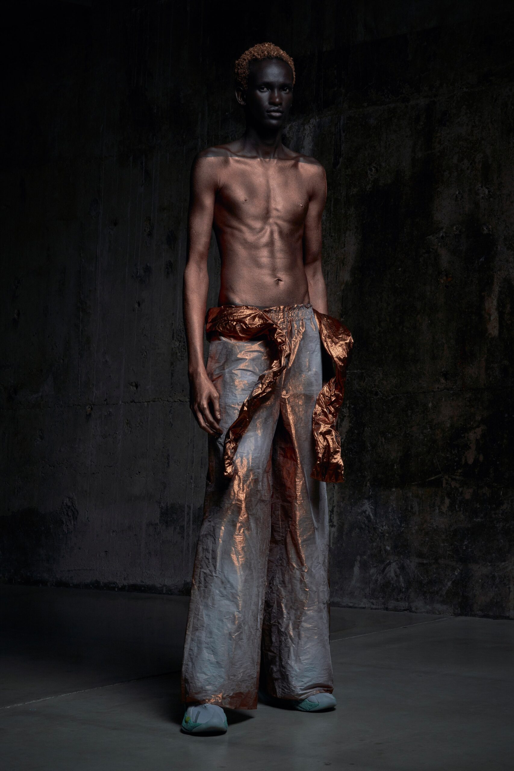 Relaxed brown silk pants with a high-waisted design and asymmetric detailing.