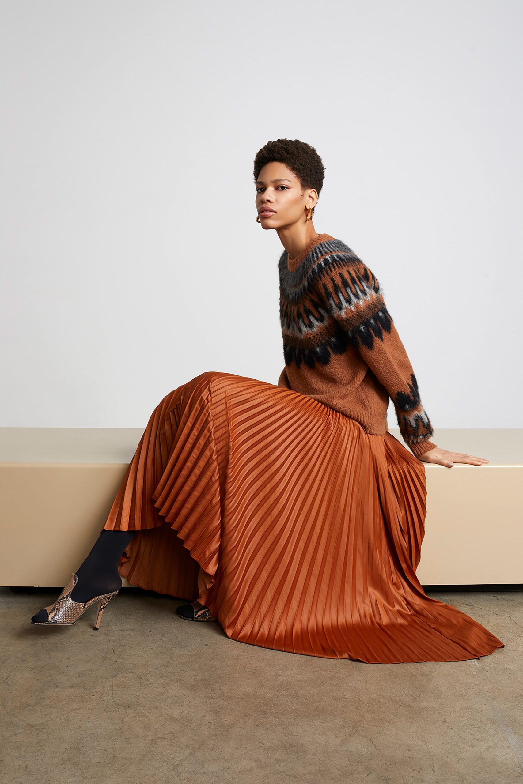 brown wool sweater and orange pleated skirt