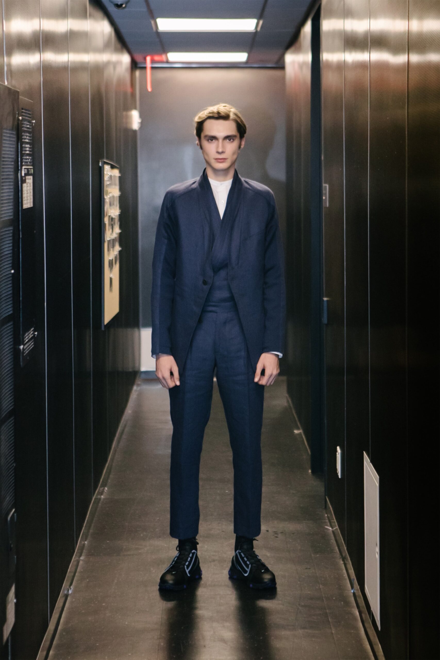 blue tailored suit with black shoes