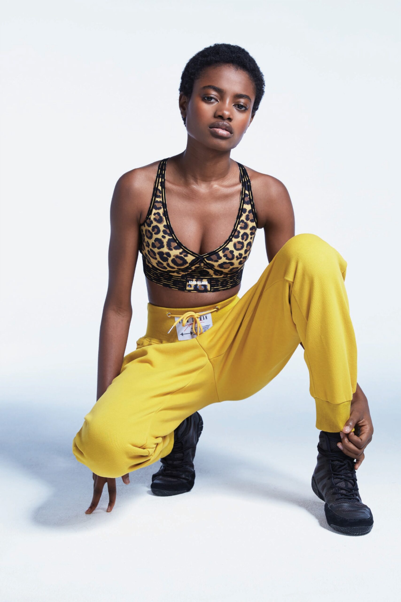 black animal-print crop-top and yellow pants