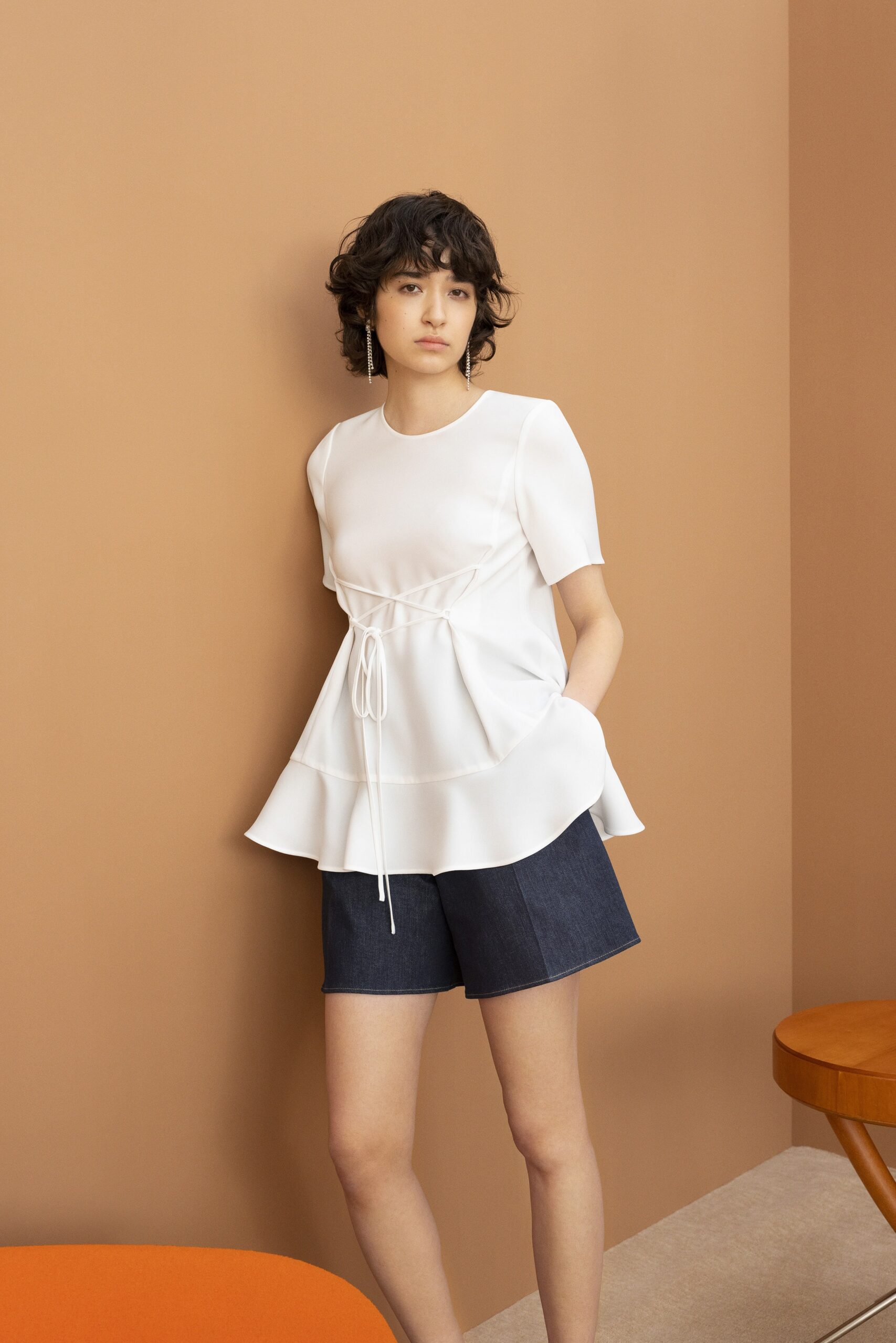 white fitted top with blue shorts