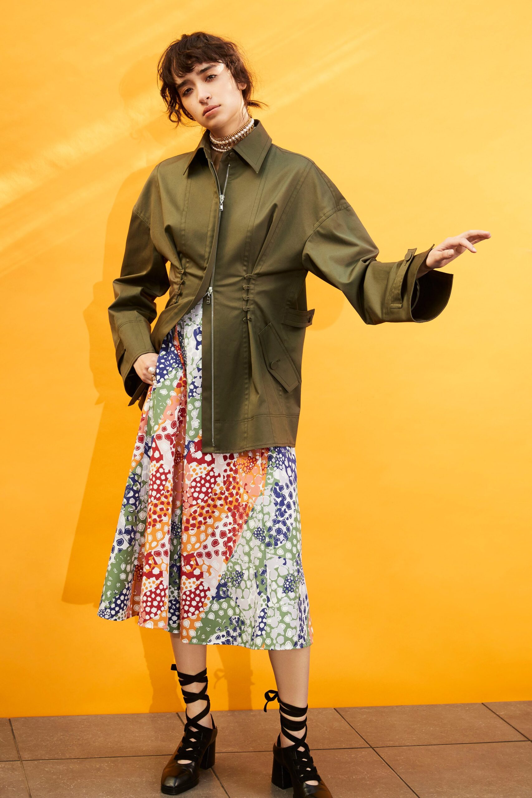 green jacket and multi dress