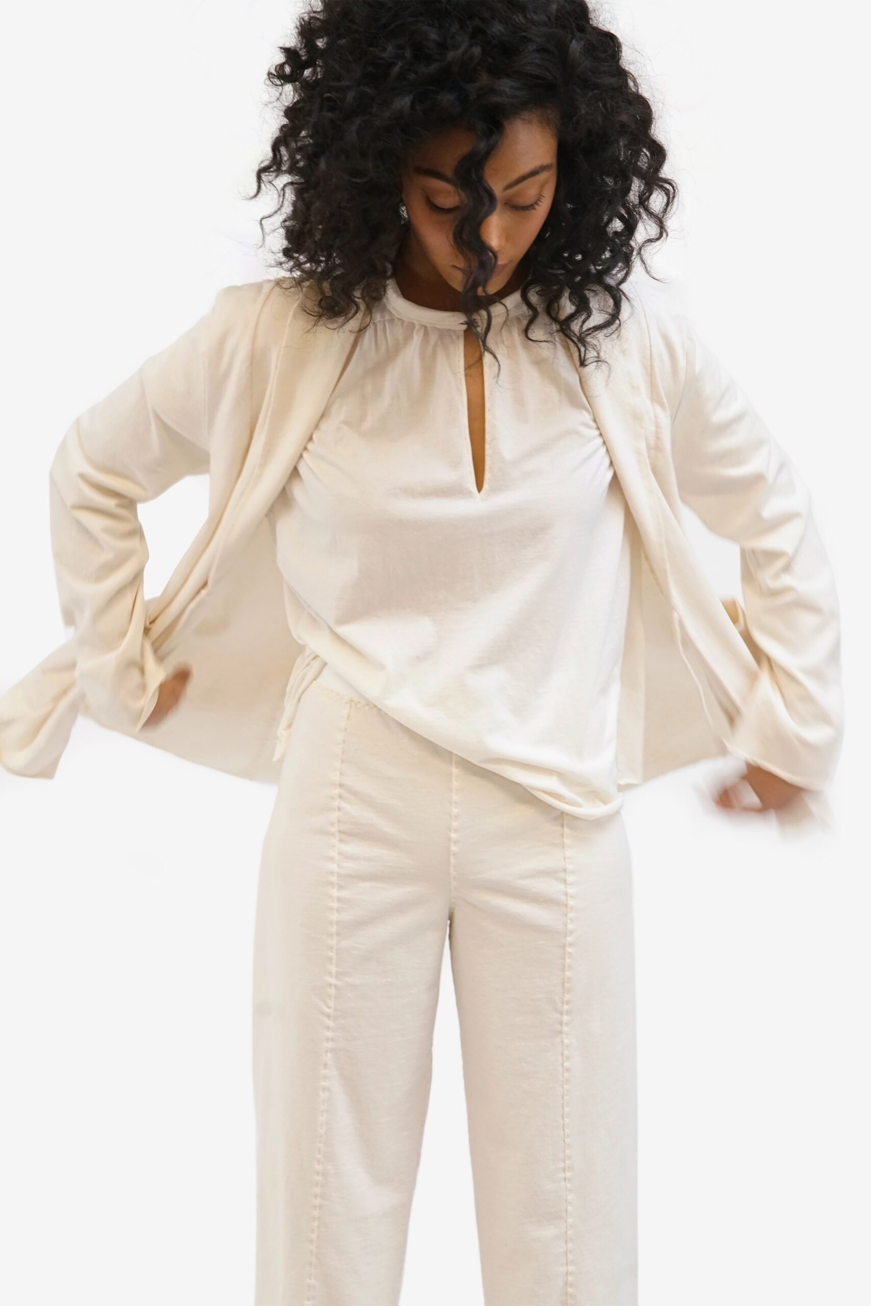 white cotton blouse with beige pants