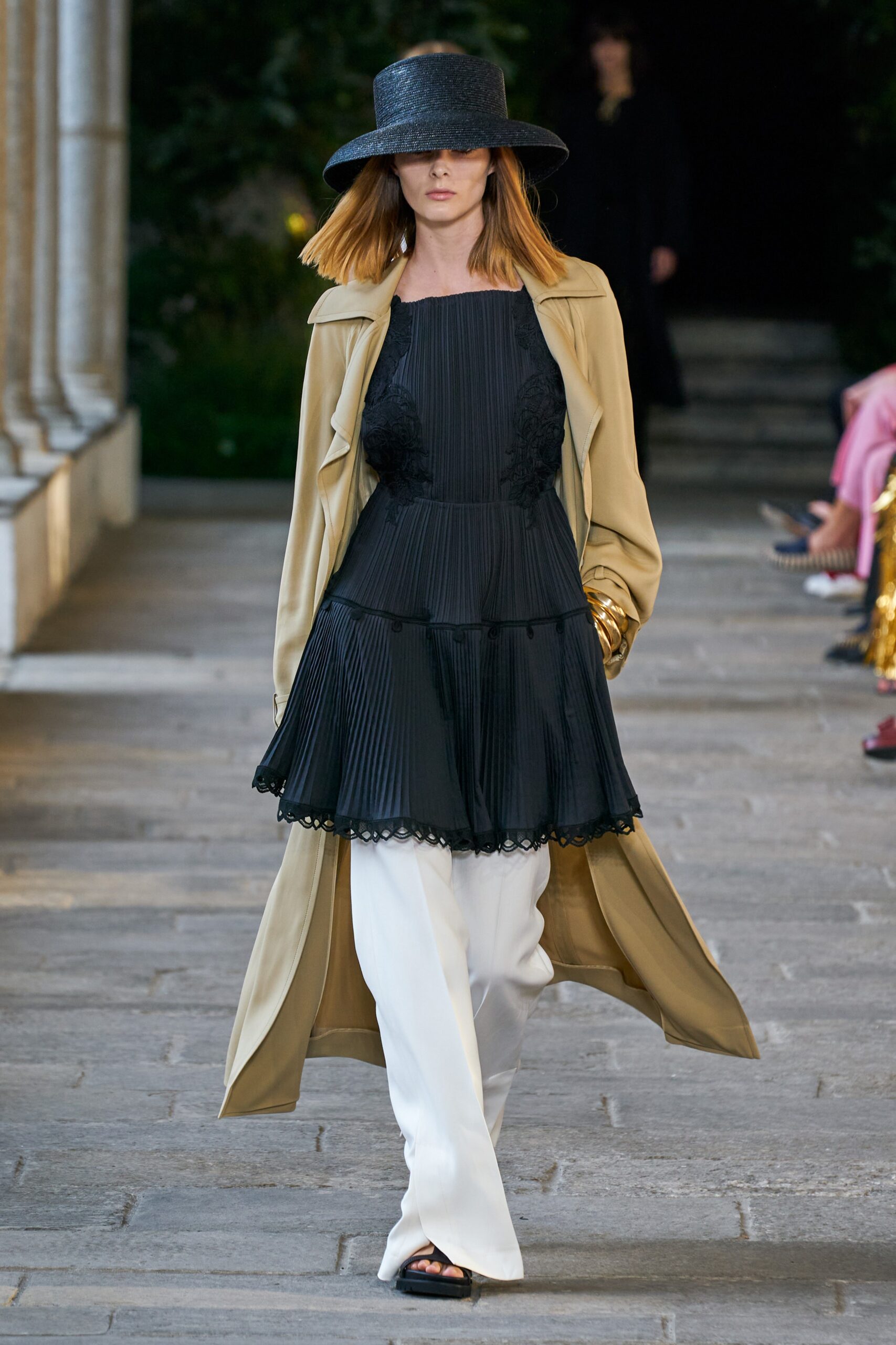 black silk pleated dress with beige coat