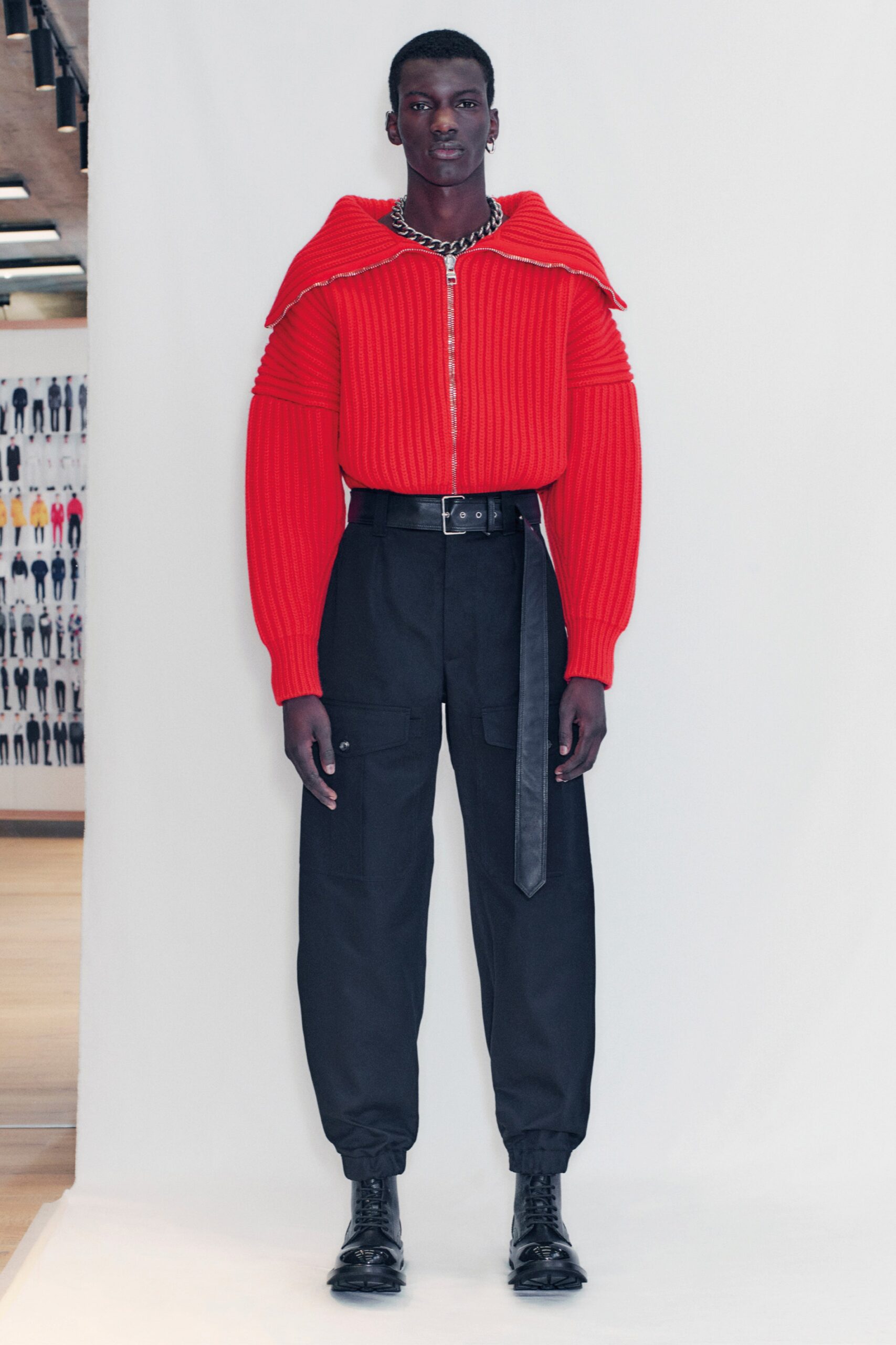 red knit fitted sweater and black cargo pants