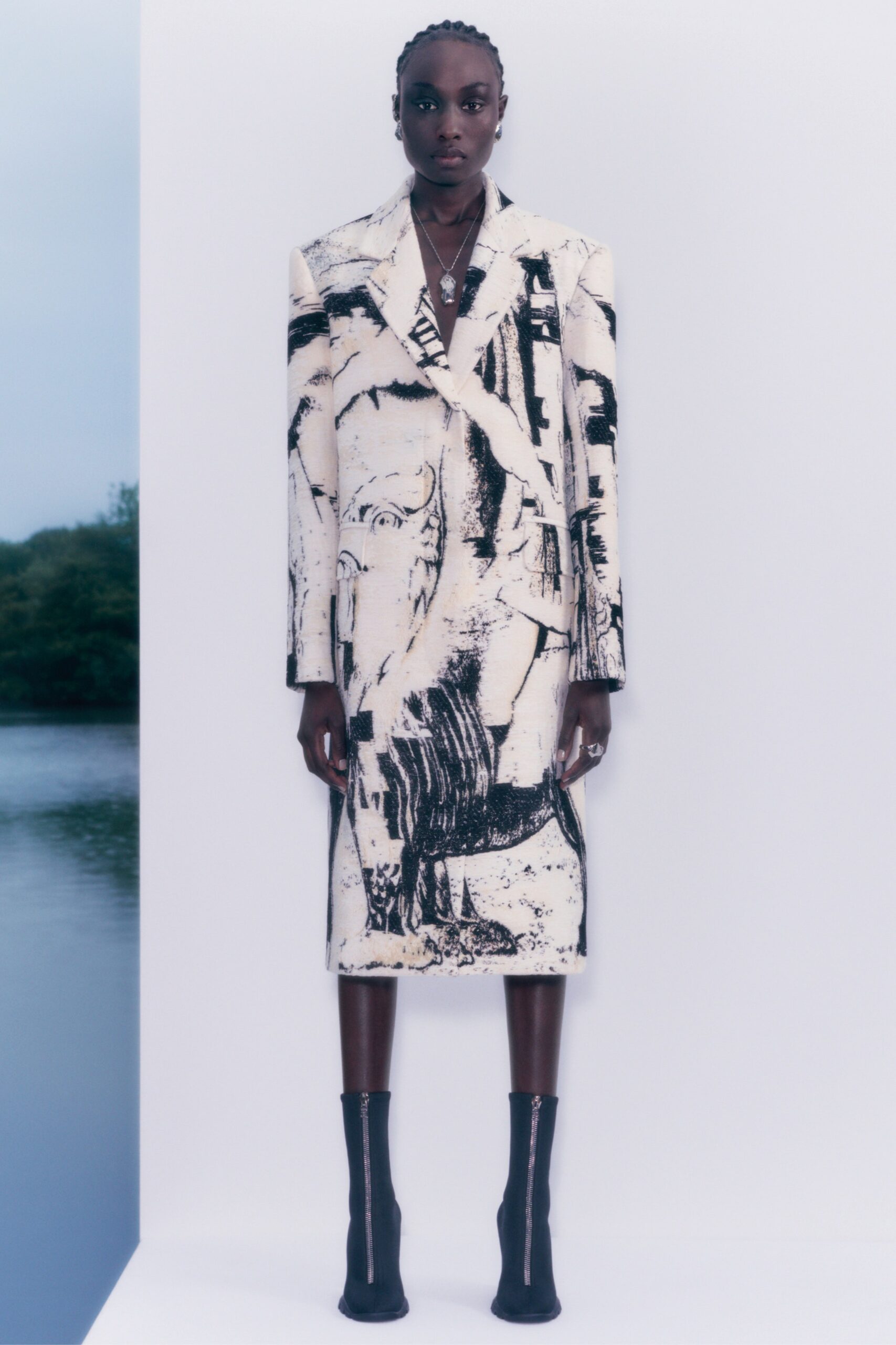 white and black printed coat with black boots