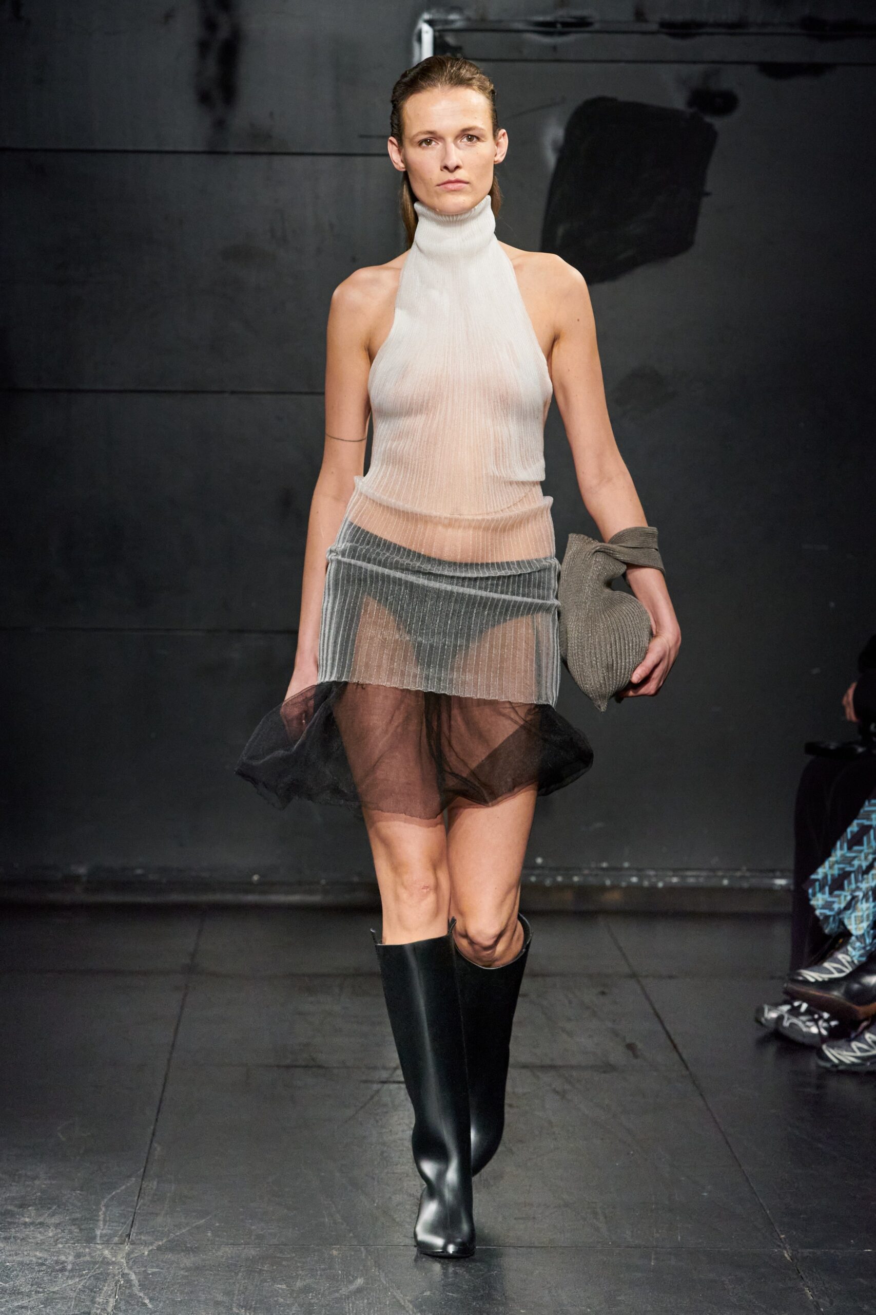 A fitted sheer dress with a high neckline and asymmetric layered design in black and white.