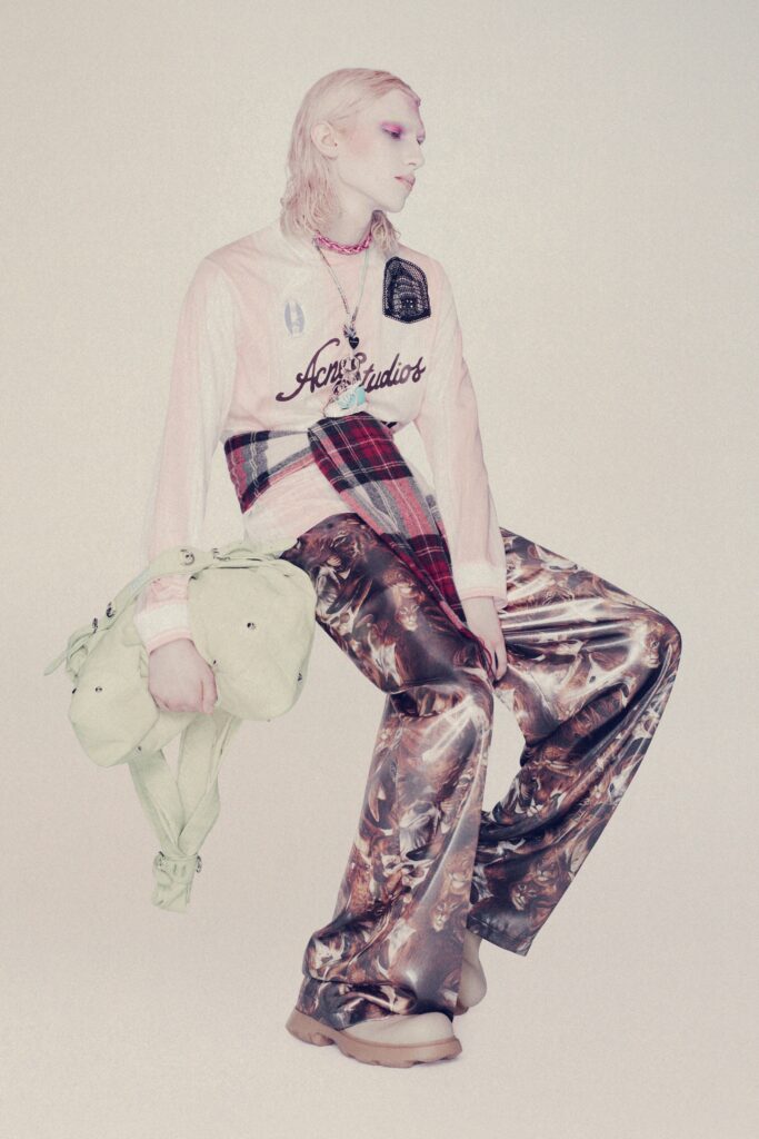 A relaxed pink printed shirt with long sleeves paired with multicolor wide-leg pants.