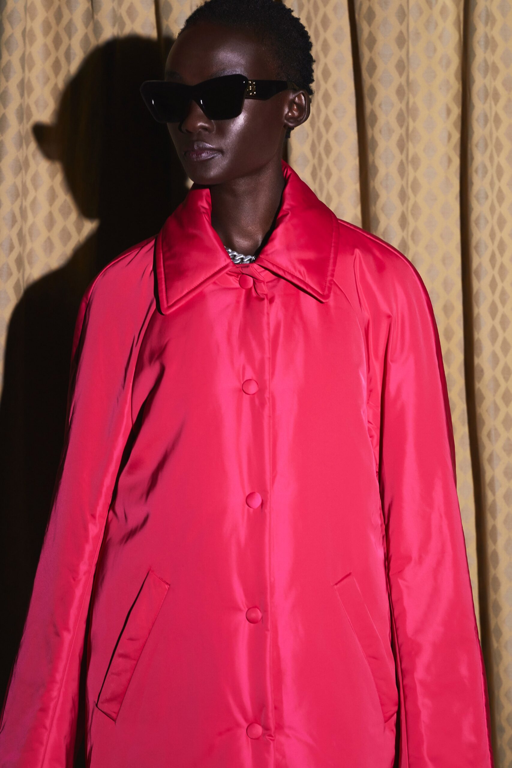 oversized red silk coat with sunglasses