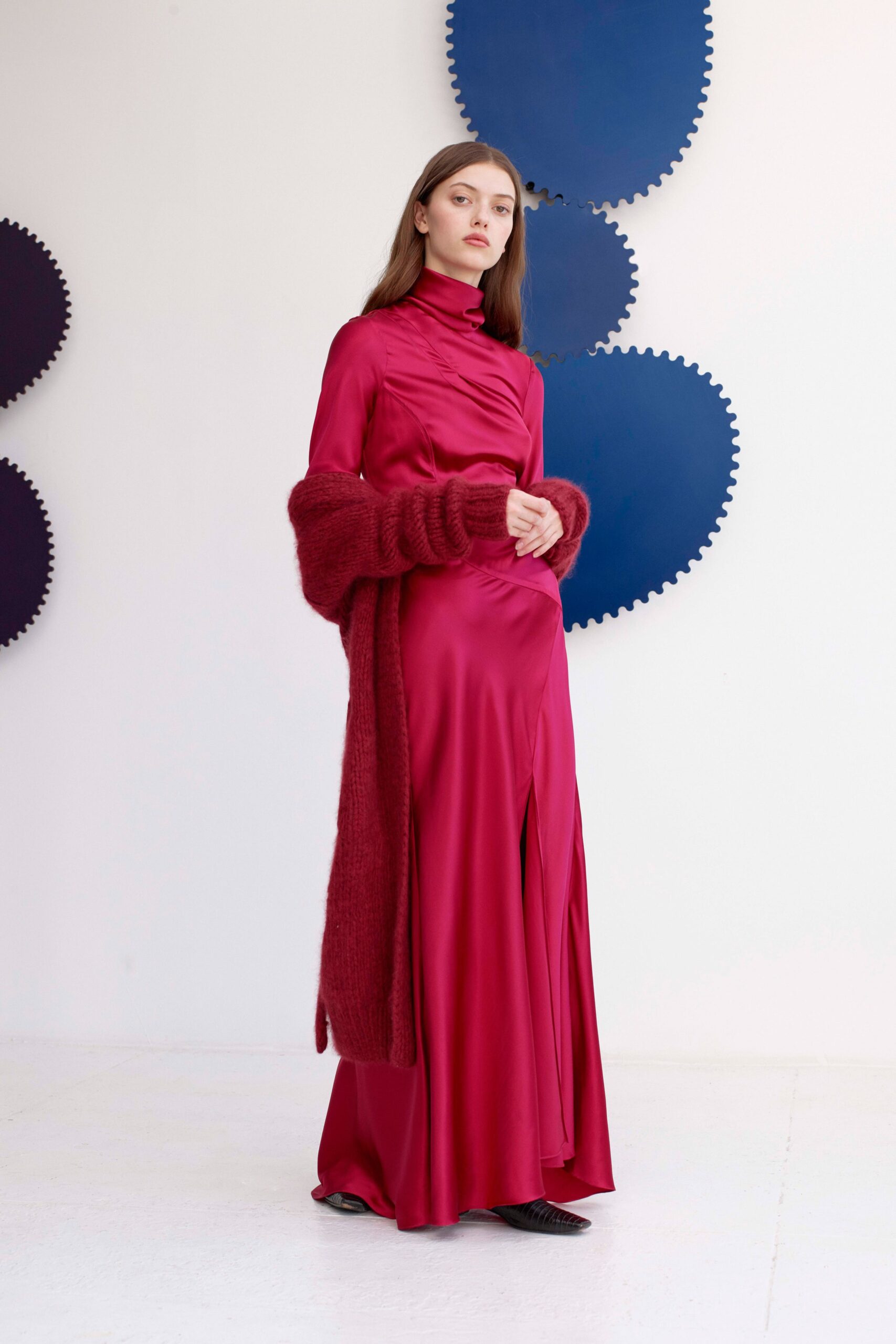 red silk gown with oversized cardigan