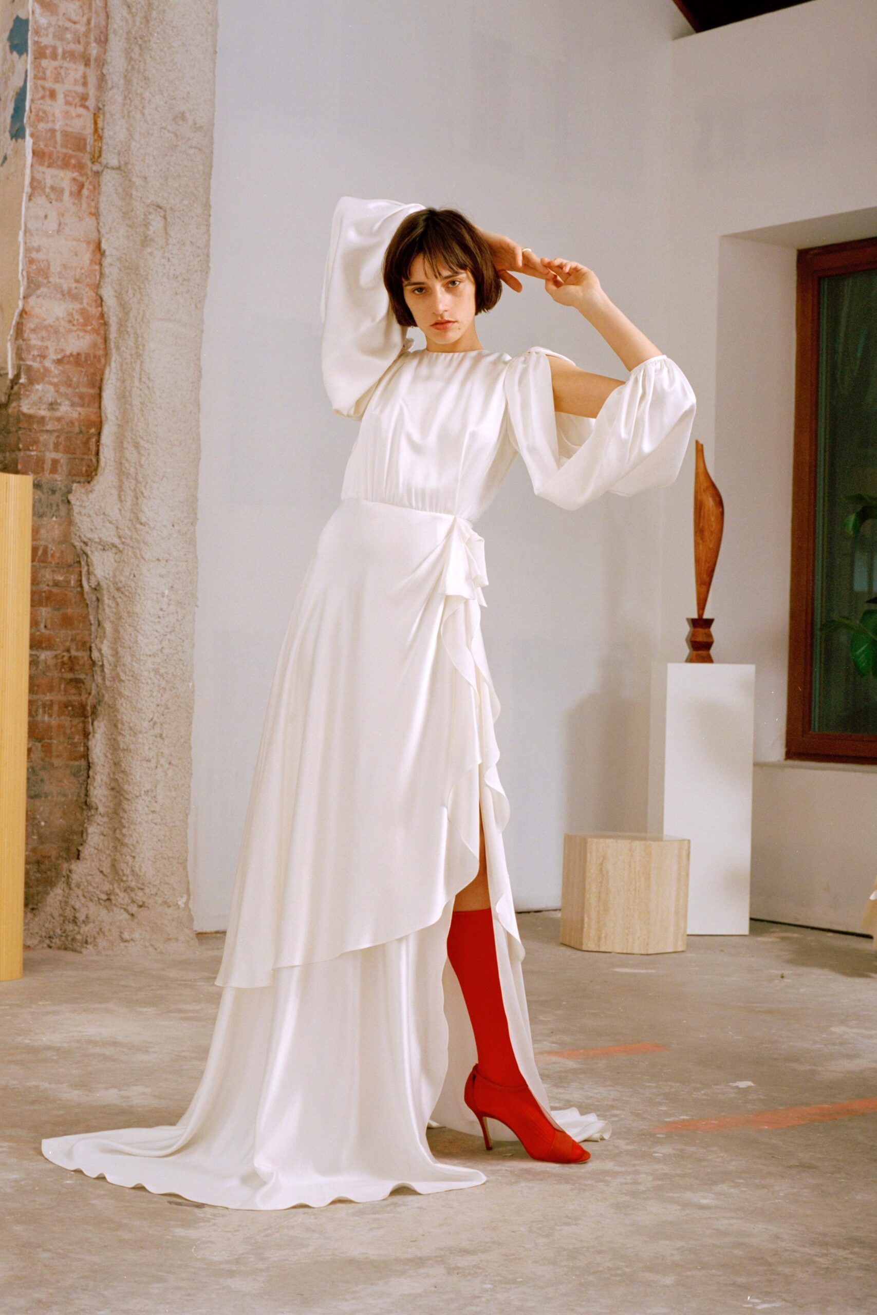 white silk draped gown