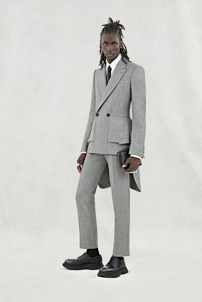 A tailored gray wool suit with a long-sleeve collared shirt and double-breasted design.
