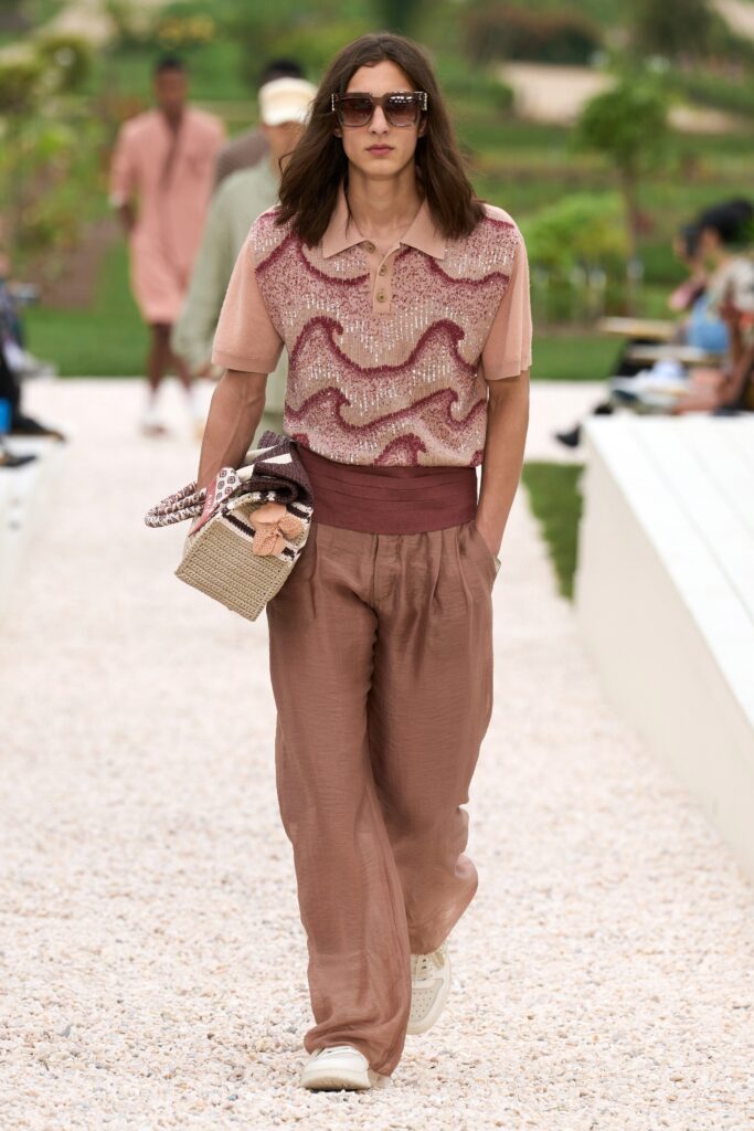 A relaxed pink printed top with a collared neckline paired with brown wide-leg pants.