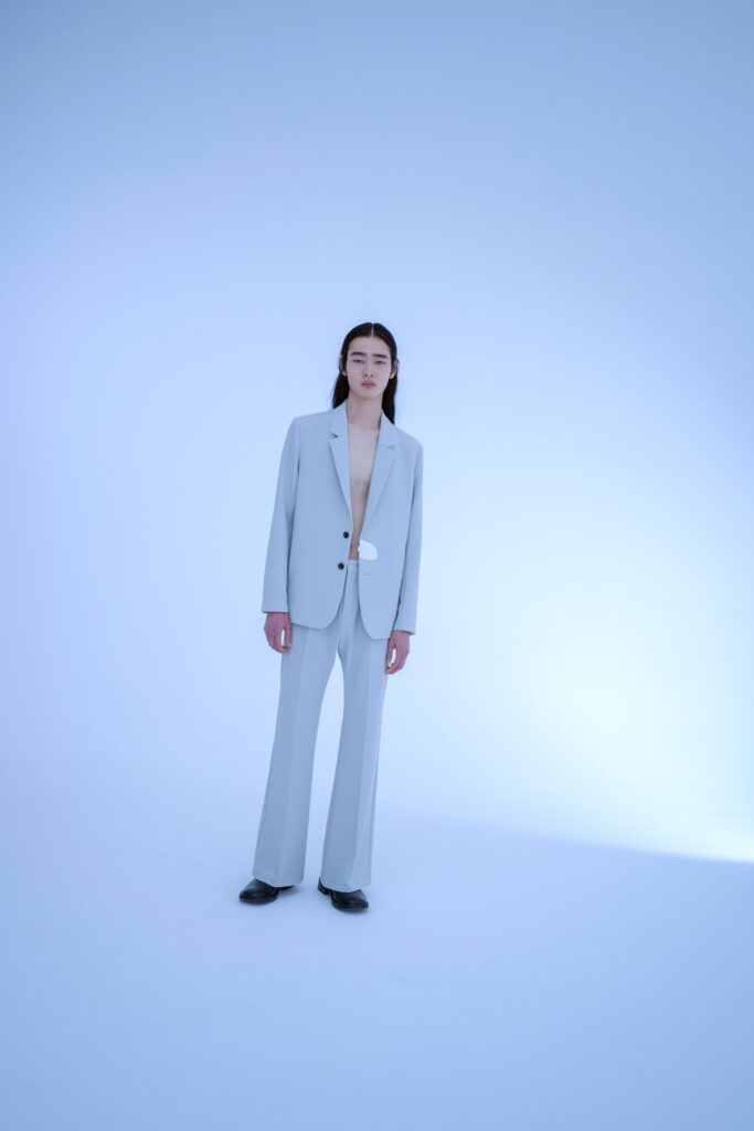 A tailored gray suit with long sleeves and a straight-leg silhouette.