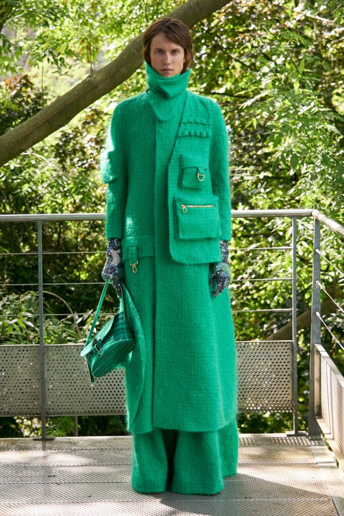 A relaxed green wool coat dress with long sleeves and a high neckline, featuring a layered design.