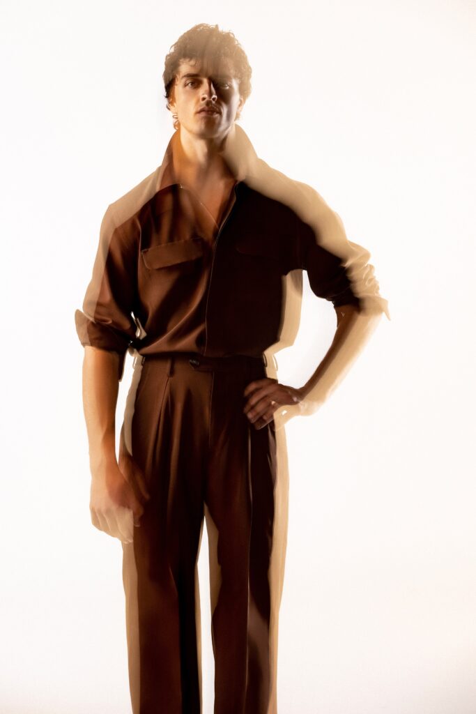 A relaxed brown cotton long-sleeve shirt with collared design paired with straight-leg pants.