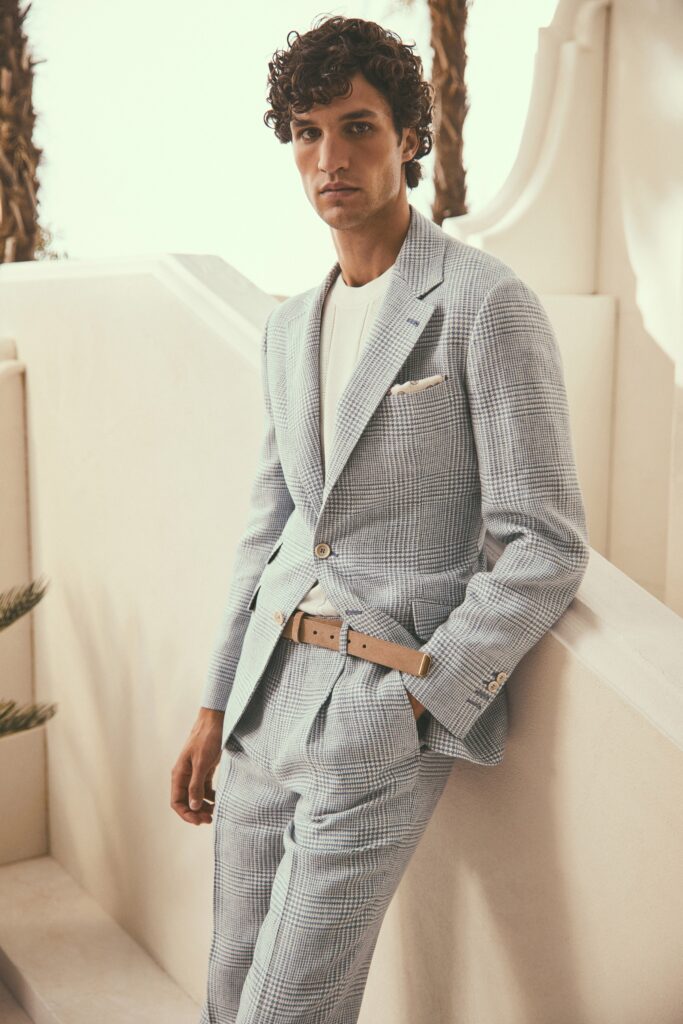 A tailored blue checked suit featuring a long-sleeve collared jacket.