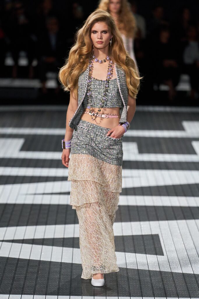 A fitted multicolor lace sleeveless top paired with a layered skirt.