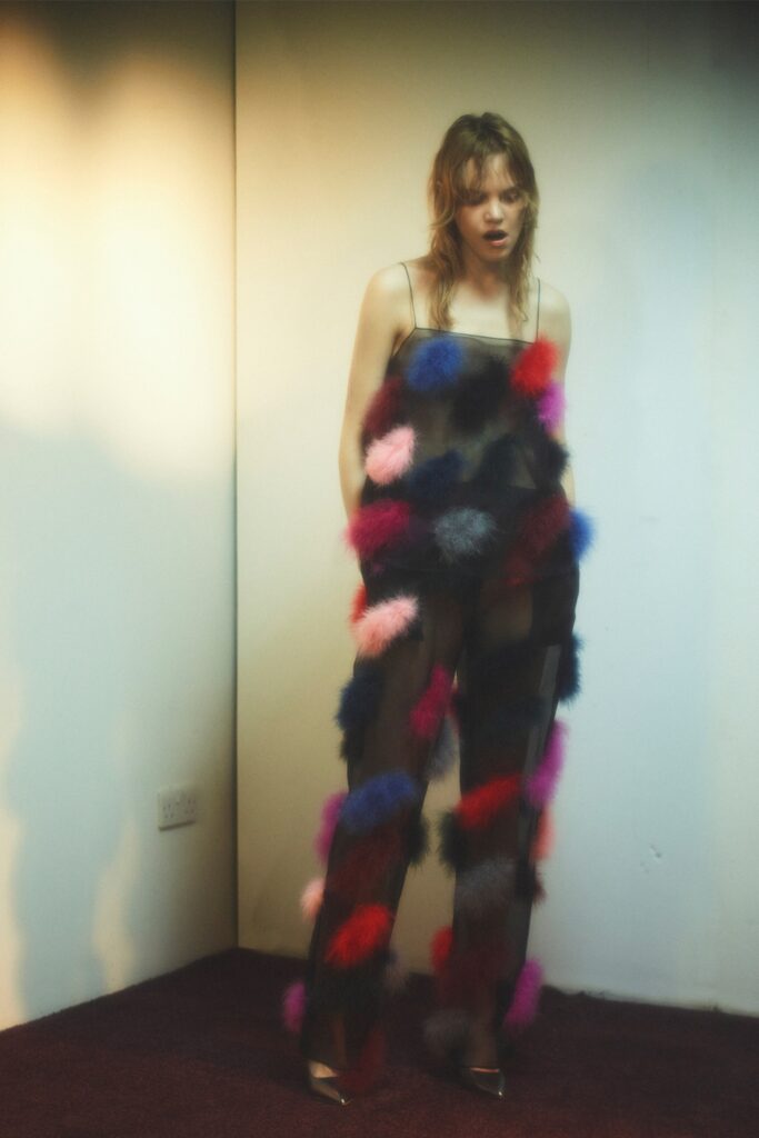 Fitted sheer pants adorned with colorful accents, creating a playful and layered look.