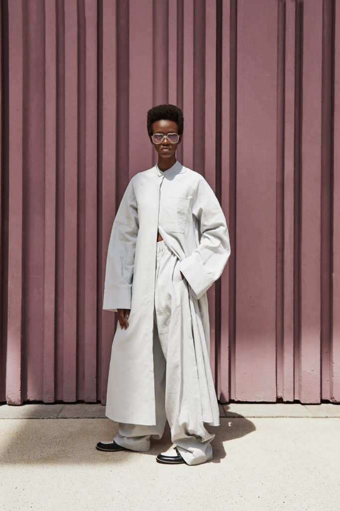A relaxed gray cotton coat with long sleeves and a collared design, paired with matching pants.