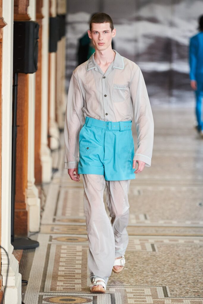 gray sheer shirt and blue shorts