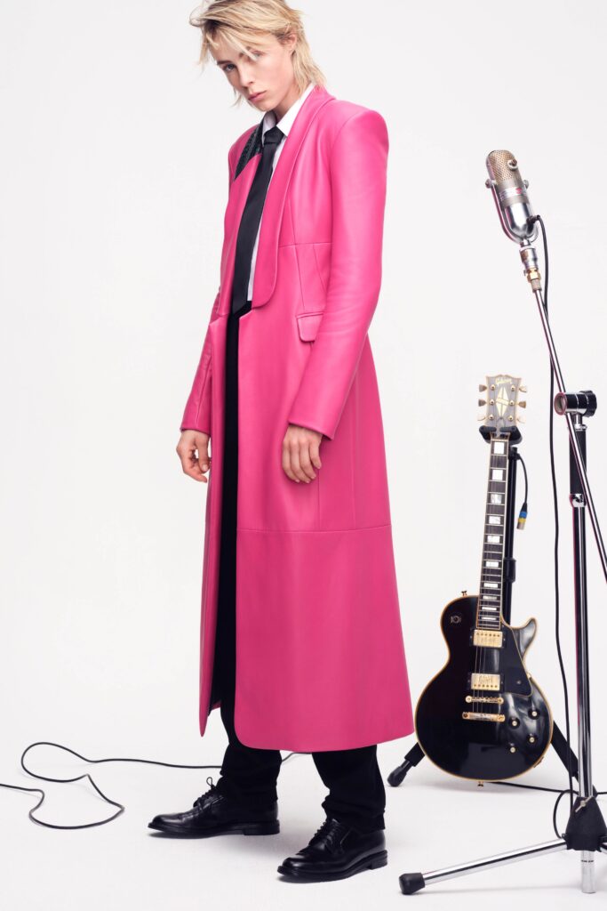 A fitted pink leather coat with long sleeves and a collared design.