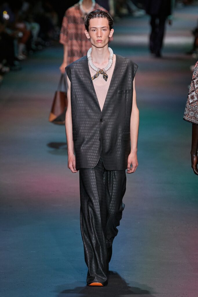 A relaxed black silk suit with a sleeveless design and asymmetric details.