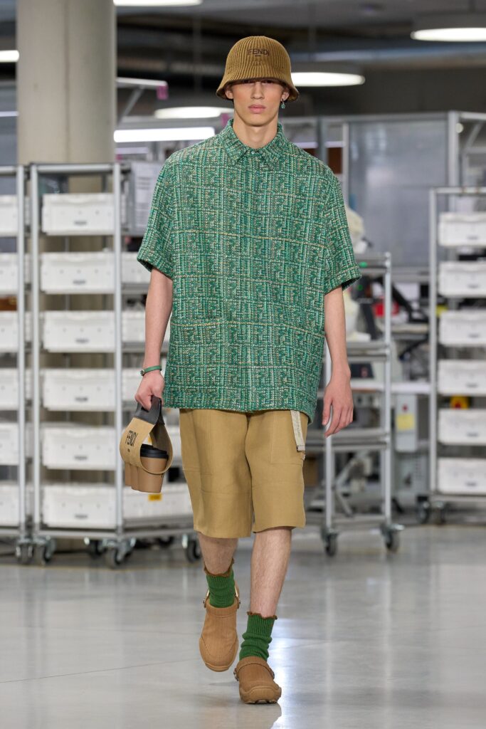 A relaxed-fit green printed shirt paired with beige shorts for a casual look.