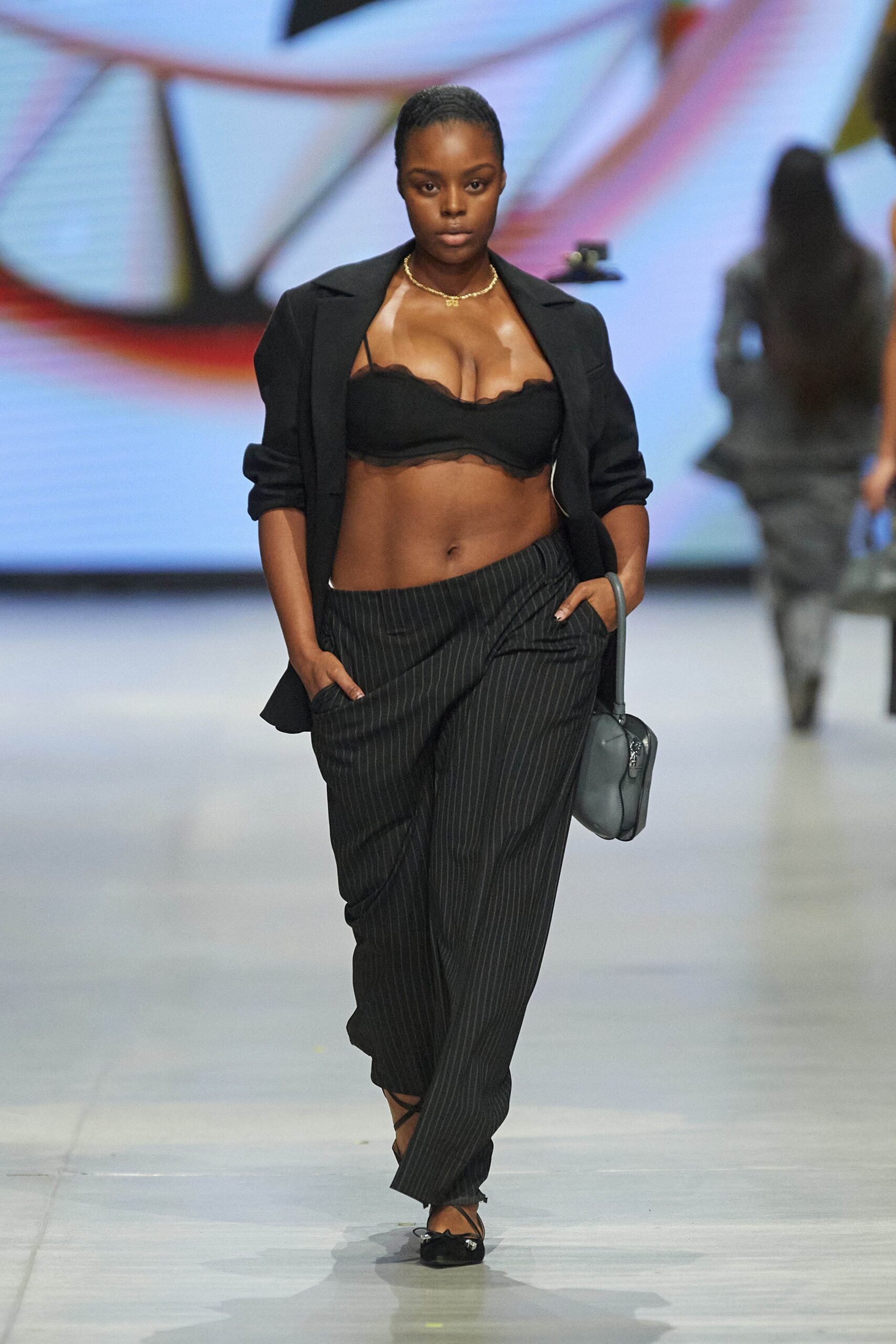 A relaxed black striped blazer paired with matching pants for a chic runway look.
