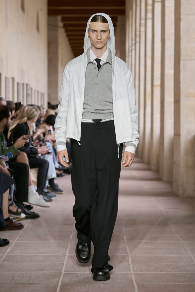 A relaxed white long-sleeve jacket paired with black pants featuring a collared design.