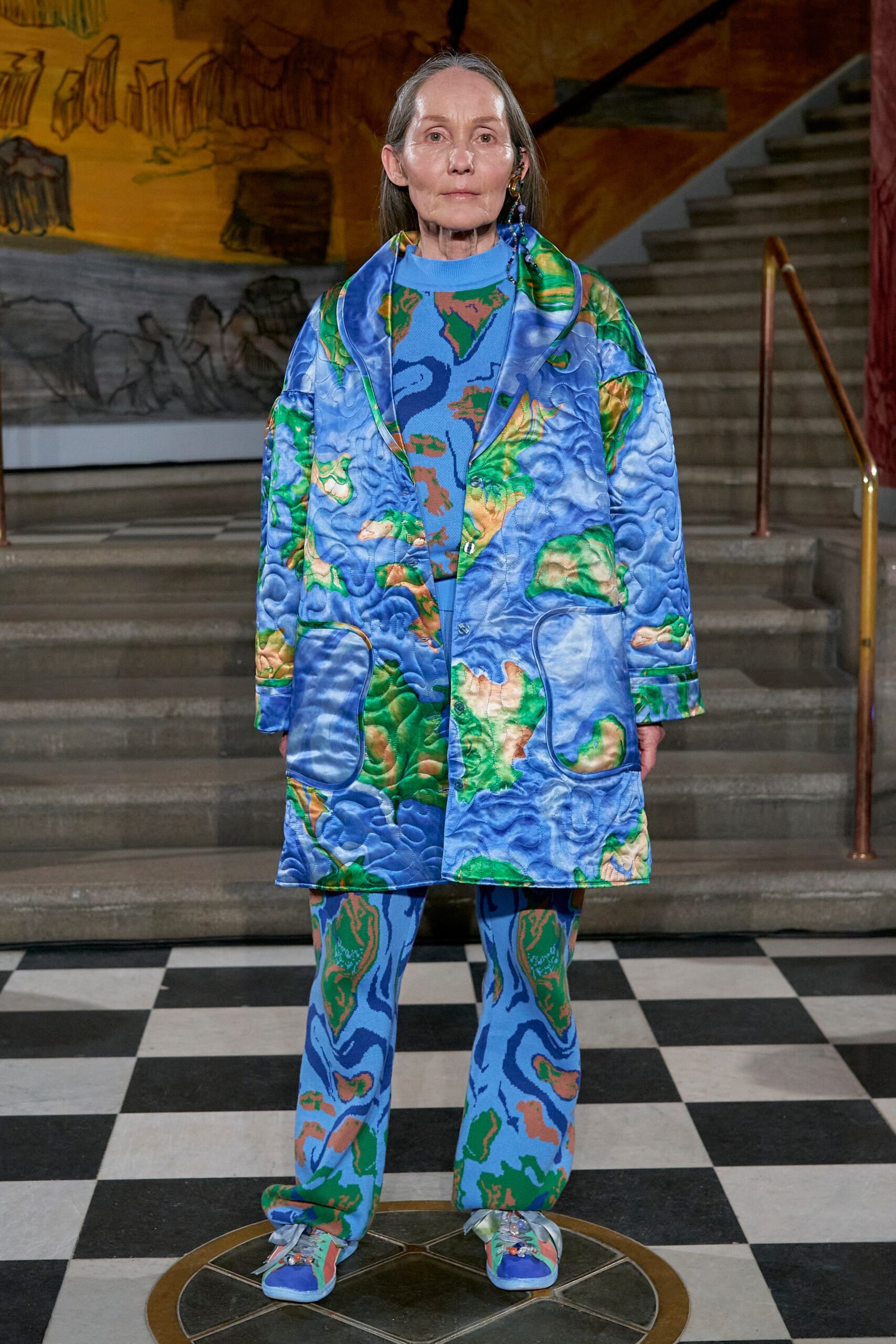 A relaxed blue printed coat paired with matching pants, showcasing a vibrant design.
