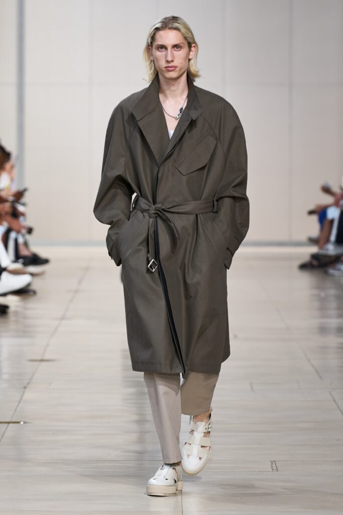 An oversized gray cotton coat with long sleeves and a belted design.